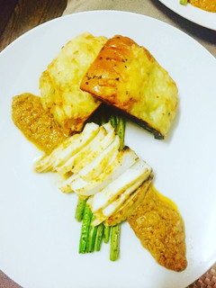 A picture of Grilled asparagus and calamari steaks with a Thai sauce.