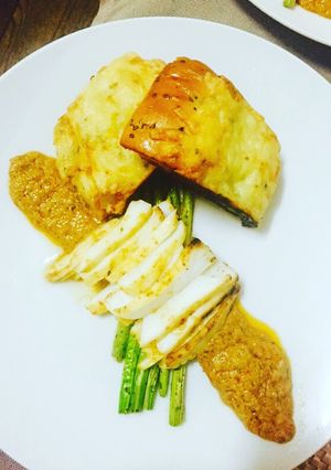 A picture of Grilled asparagus and calamari steaks with a Thai sauce.
