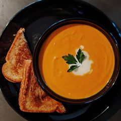 A picture of Carrot Ginger Soup with Grilled Cheese.
