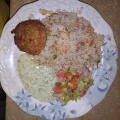 A picture of Chicken fried rice with chicken kabab.