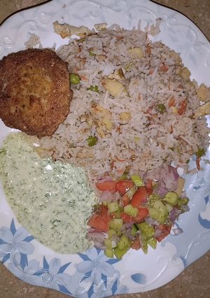 A picture of Chicken fried rice with chicken kabab.