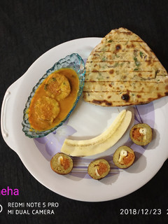 A picture of Banana kofta stuffing with carrot halwa.