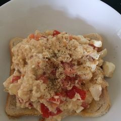 A picture of Scrambled egg with feta and tomato.