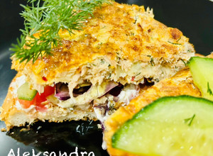 A picture of Omelette with canned tuna on toast.
