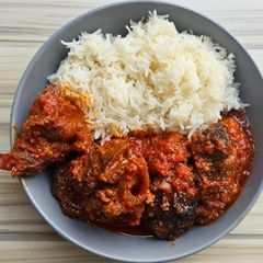 A picture of White rice and chicken stew.