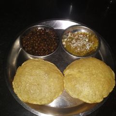 Ashtami special prasaad the puri chana and halwa thali A picture of Ashtami special prasaad the puri chana and halwa thali.