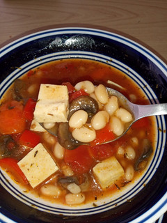 A picture of Earthy bean stew with tofu chunks.