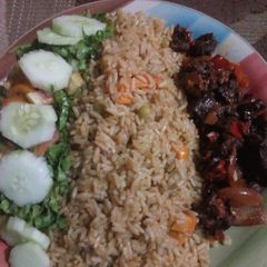 A picture of Fried rice and pepper meat and salad.