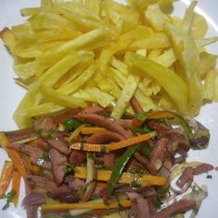A picture of Plain french fries and smokies with mixed veggies.