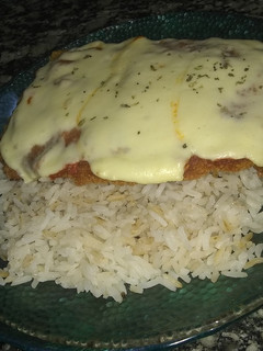 Una foto de Milanesas a la napolitana con Arroz graneado