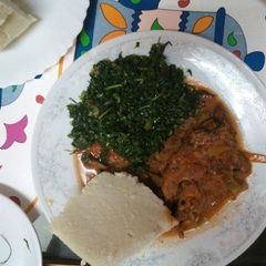 A picture of Marinated Fish and ugali and greens.