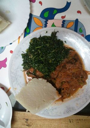 A picture of Marinated Fish and ugali and greens.