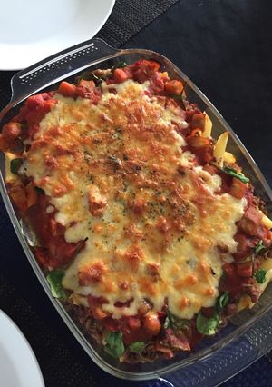 A picture of Baked meaty pasta with spinach,tomato and aubergine.