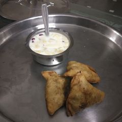 Samosa with fruit salad A picture of Samosa with fruit salad.