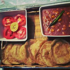 A picture of Chickpea(Chole)curry and carom (ajwian) poori.