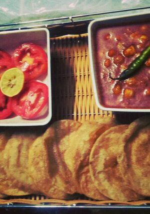 A picture of Chickpea(Chole)curry and carom (ajwian) poori.
