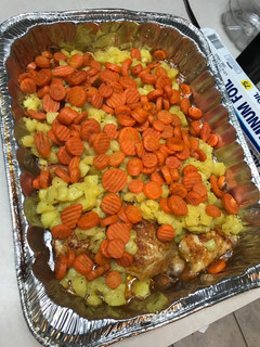 A picture of Baked Chicken w/ potatoes and carrots.