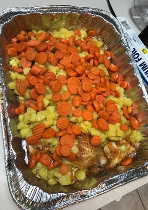 A picture of Baked Chicken w/ potatoes and carrots.