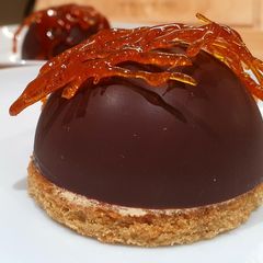 A picture of Chocolate shells with caramel mousse.