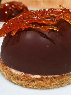 A picture of Chocolate shells with caramel mousse.