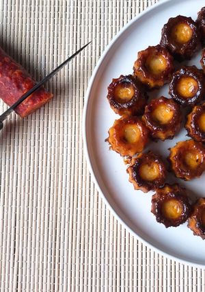 A picture of Mini Canelés with Chorizo and Comté Cheese.