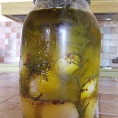 A picture of Pickled boiled eggs with herbs.