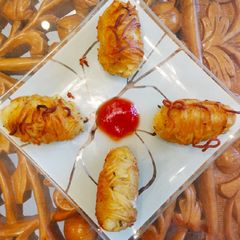 A picture of Potato cutlets rolled with Noodles.