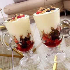 A picture of Fruit salad parfait with shortbread cookie crumble.