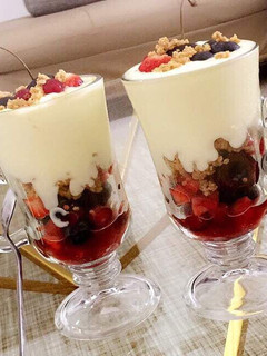 A picture of Fruit salad parfait with shortbread cookie crumble.