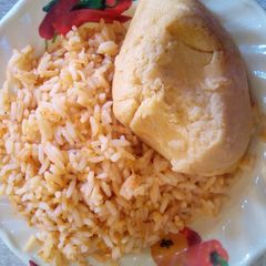 A picture of Guragura jollof rice and moimoi.