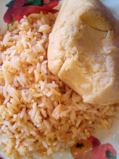 A picture of Guragura jollof rice and moimoi.