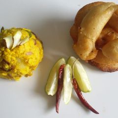 A picture of Sel roti (Nepalese sweet bread) with tangy alu chutney.