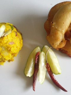 A picture of Sel roti (Nepalese sweet bread) with tangy alu chutney.