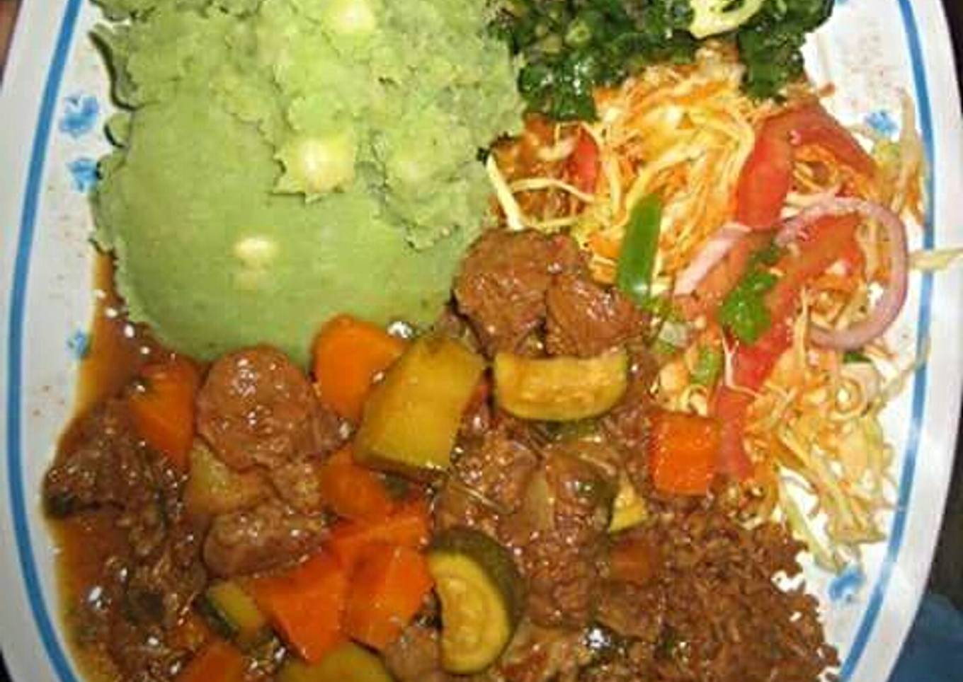 Mukimo served with beef stew and green vegetables