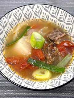 A picture of Nutritious and Slightly Spicy 'Daikon Tomato Beef Rib Soup'.