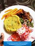 Mashed potatoes served with peas and meat