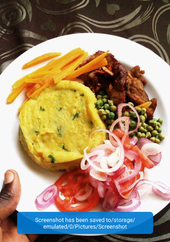 A picture of Mashed potatoes served with peas and meat.