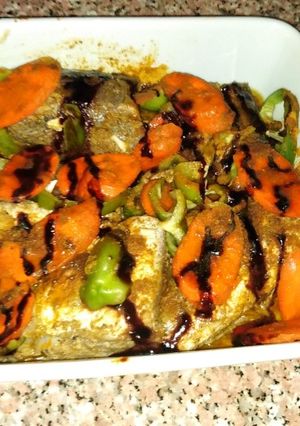 صورة لوصفة سمك مقطوع راسه مدخن بدبس الرمان 😋