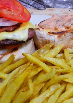 A picture of Cheese and bacon Burger and Fries.