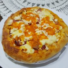 A picture of Pizza covered with homemade Mozzarella Cheese & Sausage.