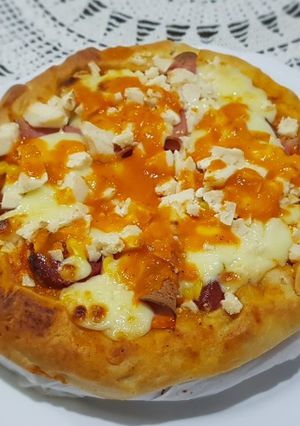 A picture of Pizza covered with homemade Mozzarella Cheese & Sausage.