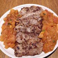 A picture of Pork Chop with Sauteed Fresh Tomatoes.