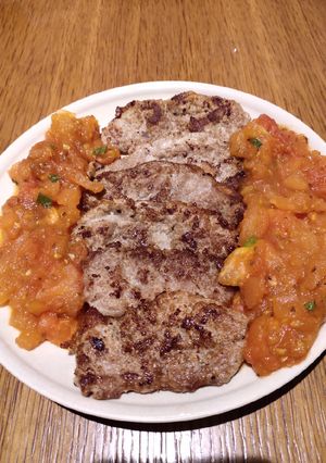 A picture of Pork Chop with Sauteed Fresh Tomatoes.