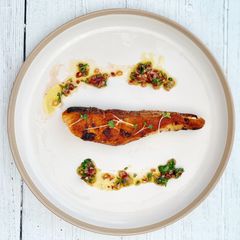 Grilled salmon served with homemade chimichurri sauce A picture of Grilled salmon served with homemade chimichurri sauce.