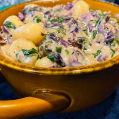 A picture of Cheesy spinach cabbage gnocchi soup.