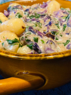 A picture of Cheesy spinach cabbage gnocchi soup.