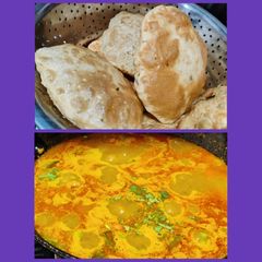 A picture of Kasuri methi poori with potato curry.