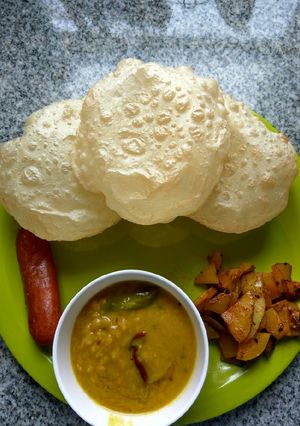 A picture of Luchi, cholar daal, aloo bhaja.