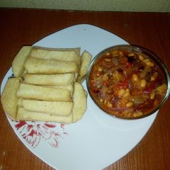 A picture of Fried yam and baked beans sauce.