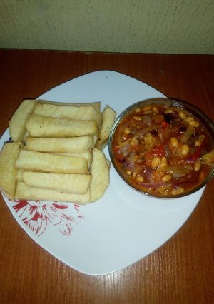 A picture of Fried yam and baked beans sauce.